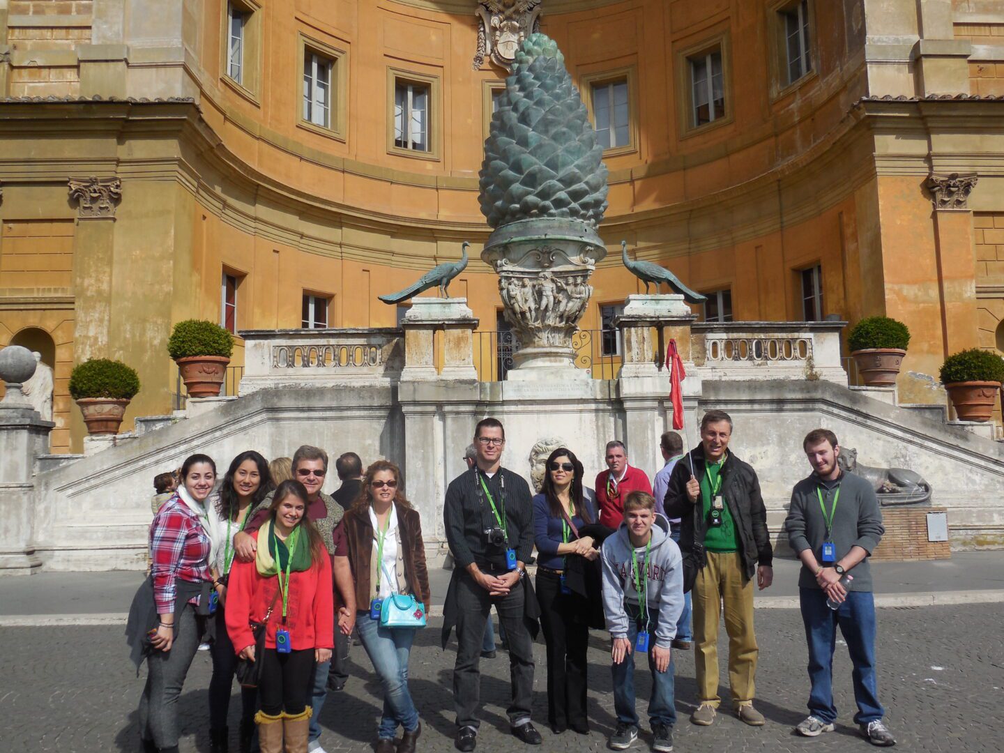 A group of people standing in front of a statue.